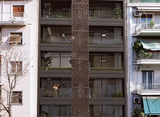 Modern residential building at Acharnon 60, Athens, featuring a distinctive brown perforated vertical screen and contemporary facade design, visualized by VARC Studio.