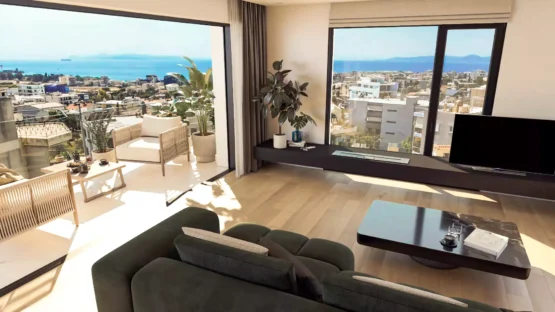 High-angle interior view of a luxury penthouse in Alimos showing the living area spacious balcony and panoramic sea view of the Saronic Gulf by Thekla Constructions