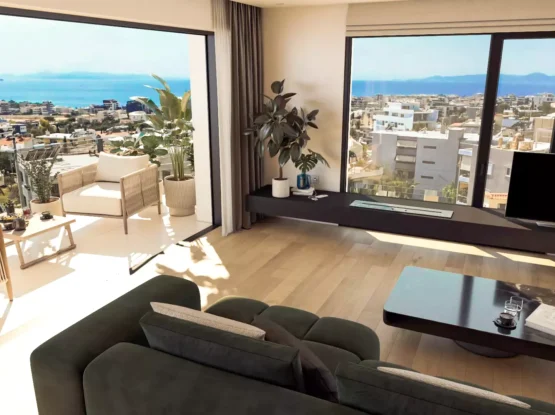 High-angle interior view of a luxury penthouse in Alimos showing the living area spacious balcony and panoramic sea view of the Saronic Gulf by Thekla Constructions