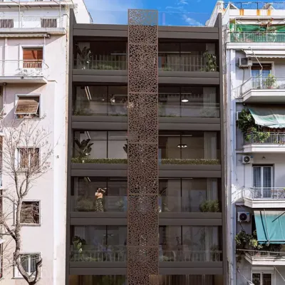 Architectural innovation on Acharnon Street – The Acharnon 60 Residential Project. Modern residential building at Acharnon 60, Athens, featuring a distinctive brown perforated vertical screen and contemporary facade design, visualized by VARC Studio.