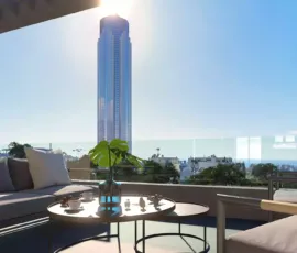 A luxury balcony featuring a modern pergola and a breathtaking view of the Riviera Tower skyscraper in Ellinikon. Modern pergola design and luxury balcony with Riviera Tower skyscraper view in Ellinikon by VARC