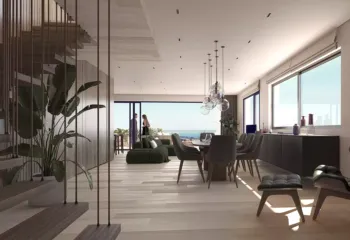 Fluid spaces and architectural precision. Project: Ikarou 7 | Developer: Thekla Constructions (2025). Luxury open-plan dining room and living area in Alimos with a modern wooden staircase glass globe chandeliers and panoramic sea view by Thekla Constructions