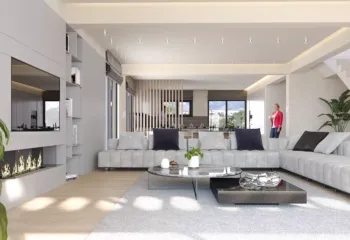 Luxury open plan living room in Elliniko by VARC Studio featuring a modern linear fireplace minimalist gray sofa marble coffee table and view of the Riviera Tower