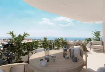 Where the sky meets the sea. Project: Ikarou 7 | Developer: Thekla Constructions. Luxury penthouse terrace in Alimos featuring a wooden dining table curved ceiling and panoramic views of the Saronic Gulf and the Metropolitan Park by Thekla Constructions