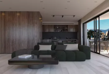 Seamless integration of utility and style. Project: Ikarou 7 | Developer: Thekla Constructions (2025). Modern minimalist kitchen with dark cabinetry integrated wood panels and green velvet sofa in a luxury Alimos penthouse by Thekla Constructions