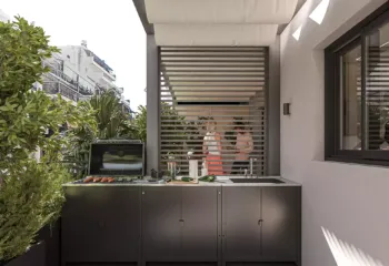 Exterior 3D architectural rendering of a modern luxury residential building at Amerikis 2 in Ano Glyfada, showcasing minimal architecture, spacious balconies, and a penthouse with a rooftop pool.