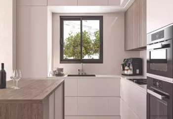 Interior 3D rendering of a renovated luxury penthouse kitchen in Pasalimani Piraeus, featuring minimalist beige cabinetry, a wooden kitchen island, and built-in appliances.