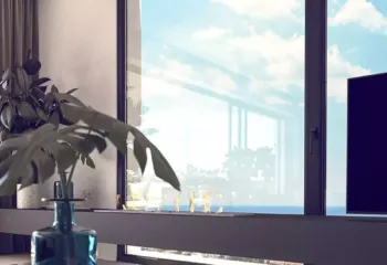 Where interior design meets the infinite blue. Project: Ikarou 7 | Developer: Thekla Constructions. Close up of a luxury penthouse interior in Alimos with a blue glass vase marble table and large window showing the Athenian sky by Thekla Constructions