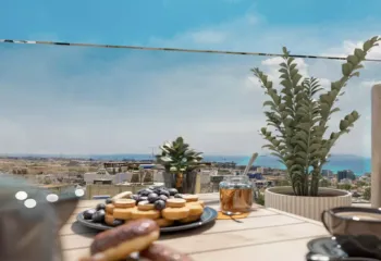 A perfect start to every day. Project: Ikarou 7 | Developer: Thekla Constructions. Close up of breakfast on a wooden terrace table with pancakes and coffee overlooking the Alimos coast and the Ellinikon Metropolitan Park by Thekla Constructions