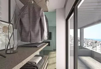 Bespoke dressing room design at Amerikis 2 | Where functionality meets high-end aesthetics. Interior 3D architectural visualization of a luxury walk-in closet in a Glyfada penthouse, featuring industrial-style shelving, high-end materials, and access to a private terrace.