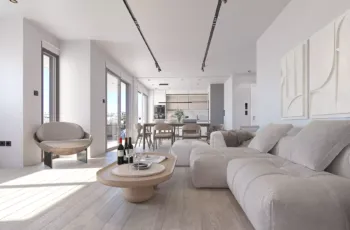High-end residential loft in Palaio Faliro featuring seamless architectural lines, premium wooden flooring, and a sophisticated minimalist aesthetic. Luxury open-plan living room with minimalist sofa and industrial lighting in Palaio Faliro Loft