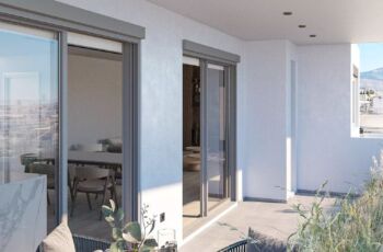 A bright and airy living space at Palaio Faliro Loft, featuring a contemporary modular sofa, minimalist decor, and high-end wooden finishes. Spacious modern living room with white modular sofa and custom furniture in Palaio Faliro Loft