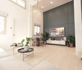 High-ceiling luxury loft living room design in Dafni Neos Kosmos, featuring modern furniture and architectural lighting, 3D visualization by VARC.