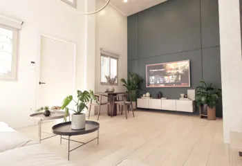 High-ceiling luxury loft living room design in Dafni Neos Kosmos, featuring modern furniture and architectural lighting, 3D visualization by VARC.