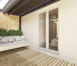 Modern balcony with wooden deck floor, built-in sofa and pergola in Agios Dimitrios