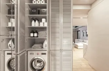 Smartly designed utility area featuring a built-in laundry station and ample storage solutions for maximum home organization. Functional laundry room with washing machine and organized storage shelves in Agios Dimitrios apartment