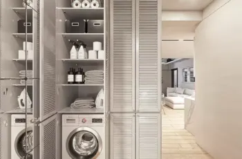 Functional laundry room with washing machine and organized storage shelves in Agios Dimitrios apartment