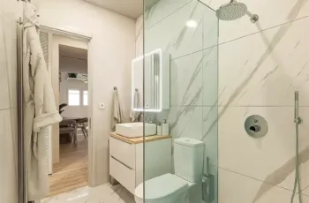 Luxury modern bathroom with marble tiles and walk-in glass shower in Agios Dimitrios