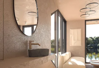 Interior 3D architectural rendering of a capsule home lifestyle showing a modern stone vessel sink with a copper faucet, an oval mirror, a cozy bouclé sofa, and large windows looking out to a lake.