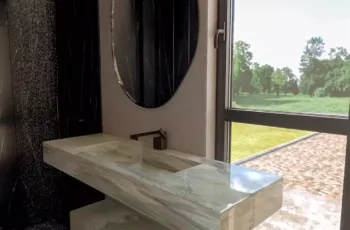 nterior 3D architectural rendering of a luxury cabin bathroom featuring a bespoke green marble vanity sink, an asymmetric mirror, a black marble shower, and a large window.