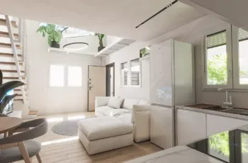 Spacious and bright open-plan interior design featuring a seamless flow between the living, dining, and kitchen areas. Open plan modern apartment layout with living room, dining area and staircase in Agios Dimitrios