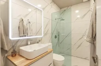 Modern bathroom vanity with led mirror and marble wall tiles in Agios Dimitrios