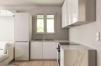 Modern white kitchen with marble countertop and high-end appliances in Agios Dimitrios apartment