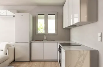 Contemporary kitchen design featuring minimalist white cabinetry and premium finishes. Modern white kitchen with marble countertop and high-end appliances in Agios Dimitrios apartment