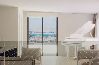 Elegant interior visualization of the PLEIADON penthouse, featuring premium furniture and panoramic views of the Saronic Gulf. Luxury penthouse interior design with white piano and sea view in PLEIADON Palaio Faliro by VARC Studio