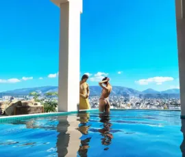 Unmatched serenity and luxury at the private pool of PLEIADON, overlooking the cityscape of Palaio Faliro. Private infinity pool with panoramic city and mountain views at PLEIADON Palaio Faliro by VARC Studio.