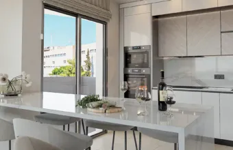 Interior architectural detail of the Papandreou Famar loft in Alimos, highlighting the modern kitchen island and cabinetry, rendered by Varc Studio.