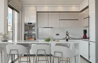 Interior architectural detail of the Papandreou Famar loft in Alimos, highlighting the kitchen island and cabinetry, rendered by Varc Studio.